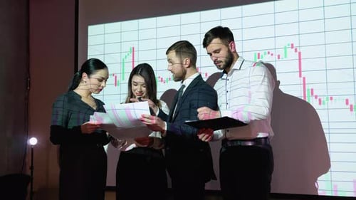Group of Businesspersons Meeting in the Office with Stock Market Chart on Background