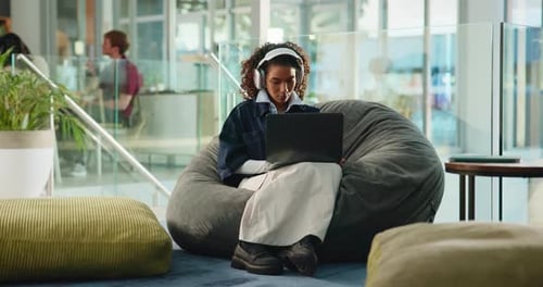 Laptop, headphones and online class with woman in college for video call, streaming and elearning