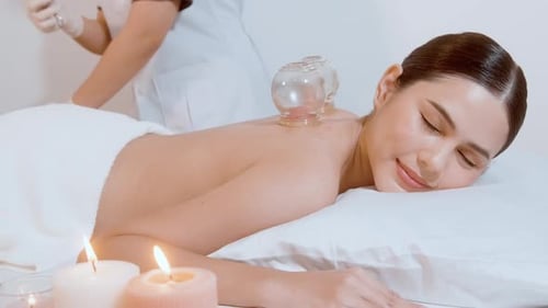 Woman Relaxing with Cupping Therapy at Spa