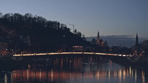 Magnificent View of Bright Illuminated Bridge Across Small River at Night with Old Stunning