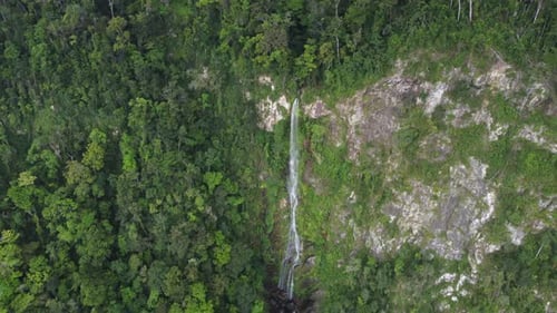 Aerial retreat from beautiful tall jungle waterfall, Cascada el Bejuco