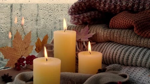 Lit Candles with Knitwear and Rainy Window