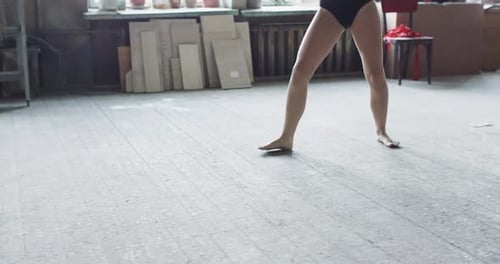 Graceful Woman Dancing in an Art Studio