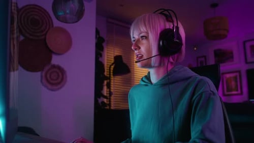 Young Adult Woman Gaming with Headset at Night