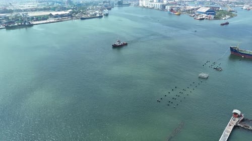 Panoramic Sea View with City Skyline and Passing Cargo Ships