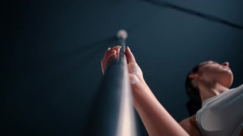 Woman Pole Dancing in Studio