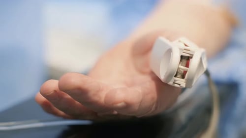 Close-up of Pulse Oximeter on Person's Hand