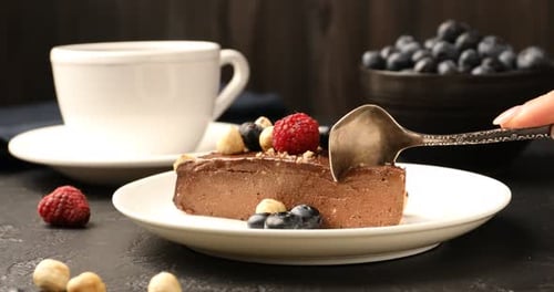 Chocolate Cake Slice Being Cut with Spoon