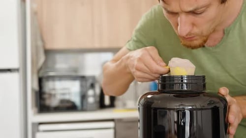 Man Smells Powder then Puts it in Jar