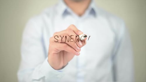 Synergy Man Writing on Transparent Screen