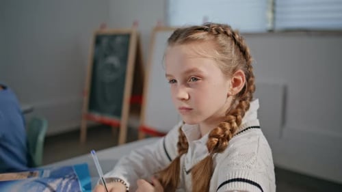Young Blonde Girl Student Working in Classroom