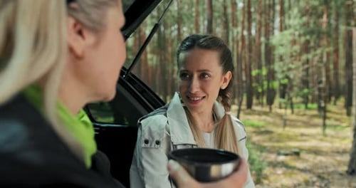 Women Friends Laughing, Talking During Road Trip Stop