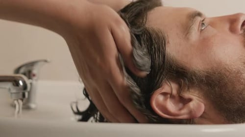 Man Getting Hair Washed at Home