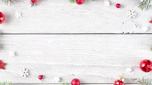 Christmas Frame Made of Snowy Fir Branches Red Decorations and Pine Cones on White Wooden Background
