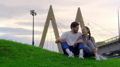 Young Couple is Enjoying Their Time in the Park They are Laughing and Smiling Clearly Having a Great