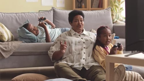 Family Enjoys Playing Video Games Together at Home