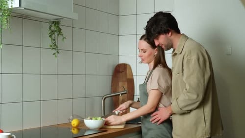 Affectionate Couple Cooking Together in Bright Kitchen