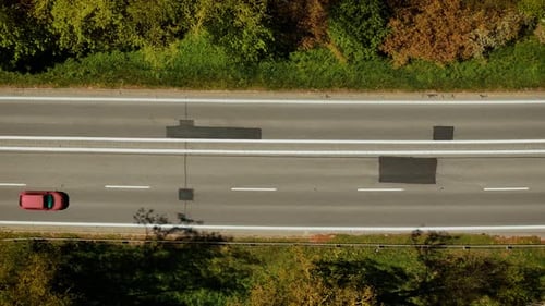 Car Driving on Road with Patches From Recent Asphalt Repair Vehicle Moving Along Lane Showing Fresh