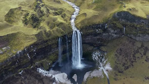 Aerial View of Waterfall in a Green Landscape