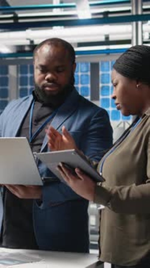 Colleagues Collaborate in Data Center Server Room