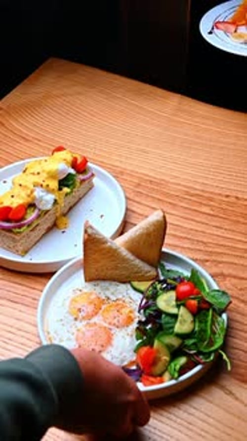 Warm breakfast with toast. A warm breakfast plate with eggs, toast and fresh vegetables.