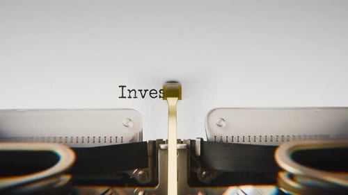 Old mechanical typewriter typing Invest In Stocks in a close-up view.