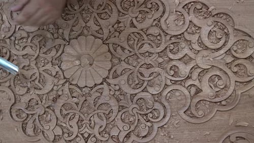 Woodworker Carving Intricate Designs with Precision and Skill