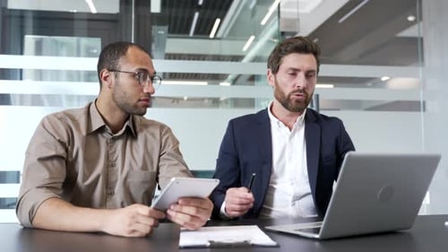 Men Discussing Business in Modern Office