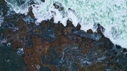 Swirling Water Foaming Coast Cliffs Zoom Out Stormy Ocean Crashing of Stones