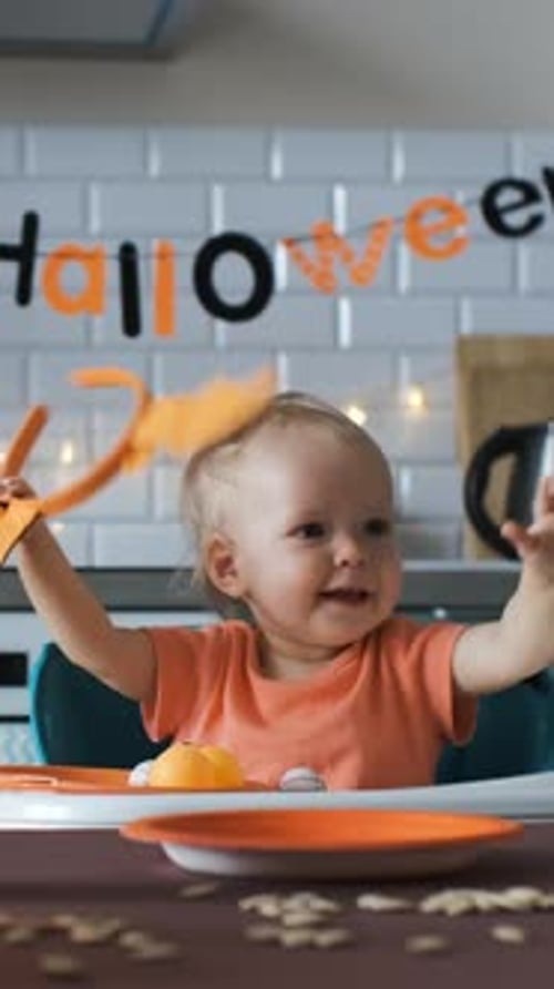 Cute Baby Celebrates Halloween in High Chair