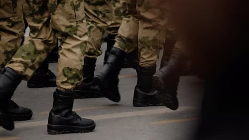 Closeup View of Soldiers in Camouflage Uniforms Marching in Formation on a City Street Black Combat
