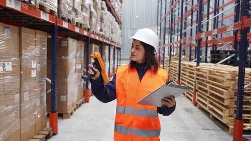 Female Warehouse Worker Scanning and Checking Inventory