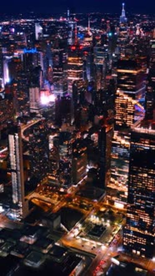 Illuminated New York streets aerial shot. Downtown building nightlife. Vertical video