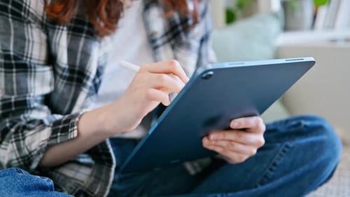 Close Up of Person Using Stylus on Tablet