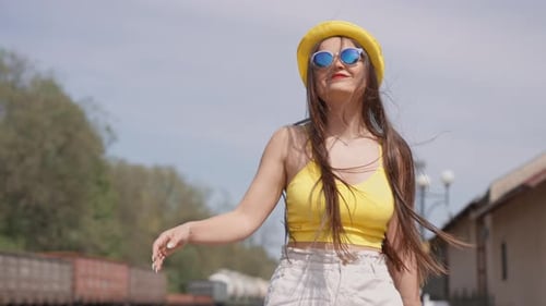 Young Woman Pulling Luggage at Railway Station
