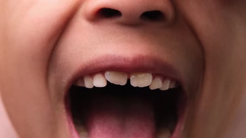 Cute little girl smile close. Close-up of young beautiful smiling girl showing her teeth isolated