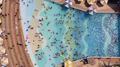 Top down aerial footage of People in a Wave pool.