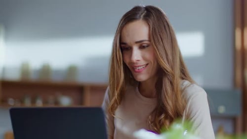 Excited Woman Reacting Positively to Laptop News