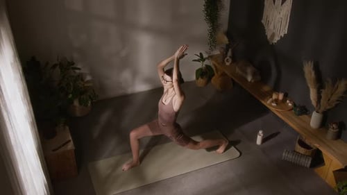 Experienced Yoga Devotee Performing Warrior Asana Flow at Home