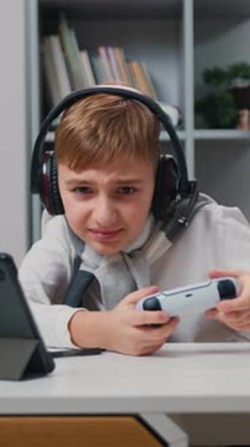 Excited Boy Playing Video Games with Controller and Headset