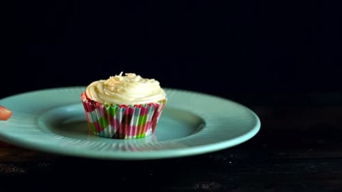 Hand Put Muffin Plate on Table. Close Up of One Tasty Muffin