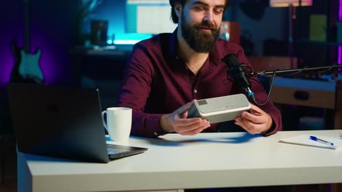Man Presents Portable Speaker at a Podcast Studio