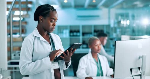 Woman Using Tablet in Modern Laboratory Setting