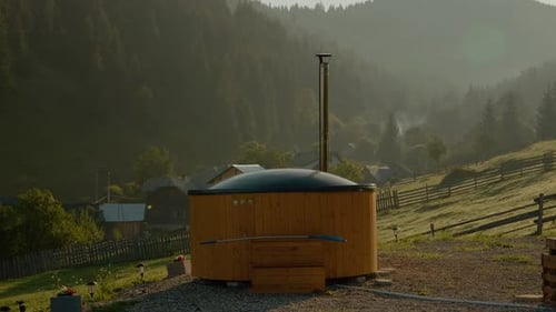 Morning retreat in a mountain landscape with a cozy cabin and fir trees