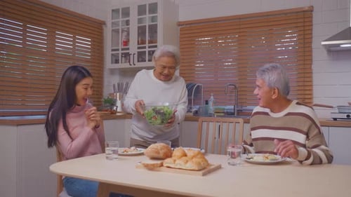 Family Mealtime With Salad in Bright Home Kitchen