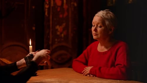 Woman Receiving a Tarot Card Reading by Candlelight