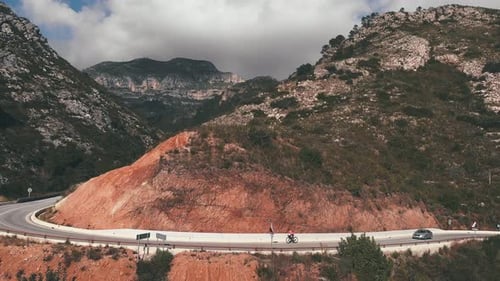 Mountain Road With Cyclist and Cars in Nature