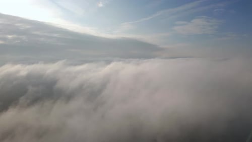 Dreamy Aerial View of Clouds Under Blue Sky