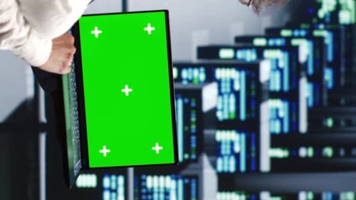 Man Uses Laptop with Green Screen Background