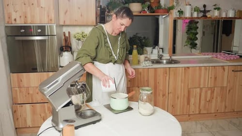 Woman Prepares Food in Bright Kitchen